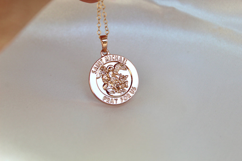 beautiful St. Michael pendant. Round, shiney, and has "Saint michael pray for us" on it with an image of st michael 