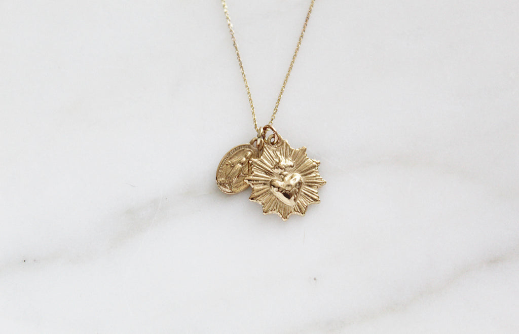 This 14k Gold Necklace has the Classic Miraculous Medal and the Sacred Heart Medal. Its handmade, the Chain is dainty.