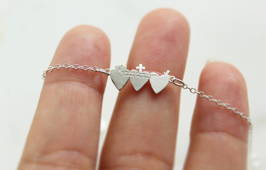 This is our Holy Family Hearts® Bracelet in Sterling Silver, the Tiny version.The design displays all three hearts of the Holy Family.  The design has The Sacred Heart of Jesus, Immaculate heart of Mary, and the most Chaste heart of St. Joseph.  The Medals size on this bracelet is  3/4" X 1/2".