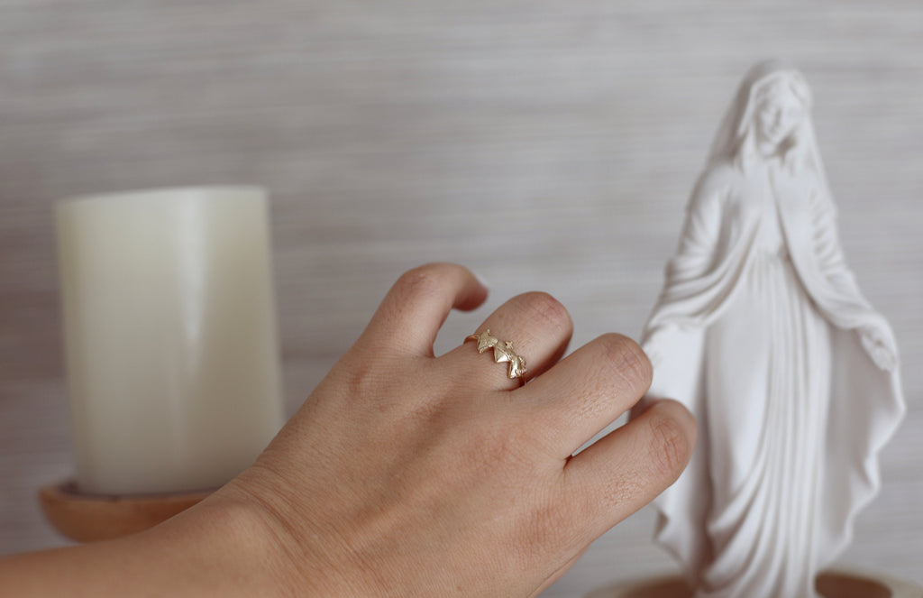 Holy Family Hearts Ring in 14K Yellow Gold. Ring has a simple round band. Ring has the Sacred Heart of Jesus, Immaculate Heart of Mary, chaste heart of st. joseph side by side with the Sacred Heart in the middle. Inside of ring is blank. Markings are expected in all handmade items.