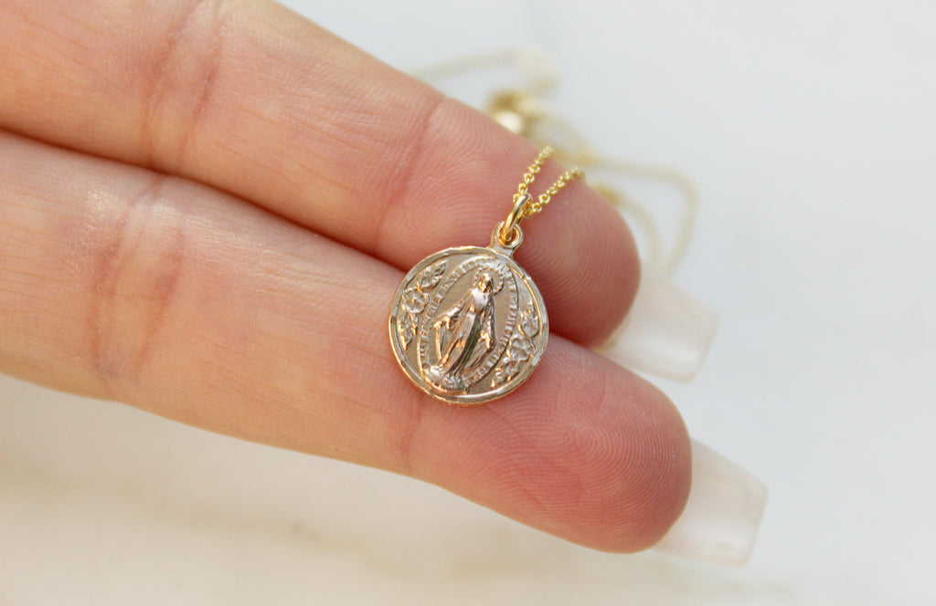 Handmade Miraculous Medal Necklace in 14K Gold. Medal is round. Chain is dainty Cable Chain. Medal Size on This Necklace is 5/16" x 1/2". Medal is Beautifully imperfect because it's handmade.