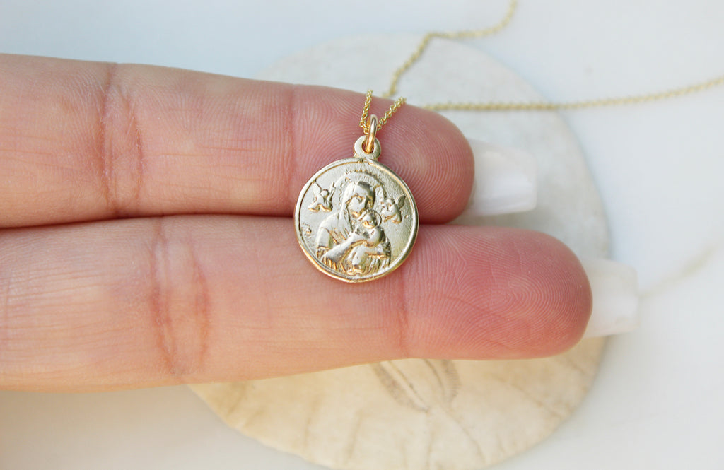 14K Yellow Gold Our Lady of Perpetual Help Necklace. Medal is handmade in USA. Medal is a circle and is 3/4"X9/16" with the loop in mind. Chain is simple and dainty. Back of Medal is blank. Markings on handmade medal are normal.