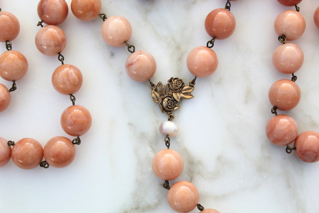 Flat Lay photo of the Saint Therese Rosary showing the Stone beads and rosary center