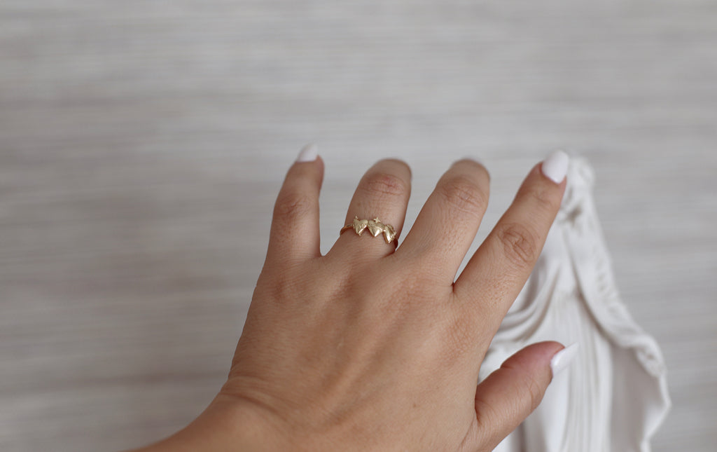 Holy Family Hearts Ring in 14K Yellow Gold. Ring has a simple round band. Ring has the Sacred Heart of Jesus, Immaculate Heart of Mary, chaste heart of st. joseph side by side with the Sacred Heart in the middle. Inside of ring is blank. Markings are expected in all handmade items.