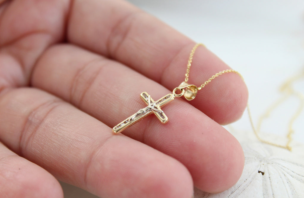 Side View of the 14K Gold Crucifix Pendant Necklace on a hand to show size of pendant and bail. 
