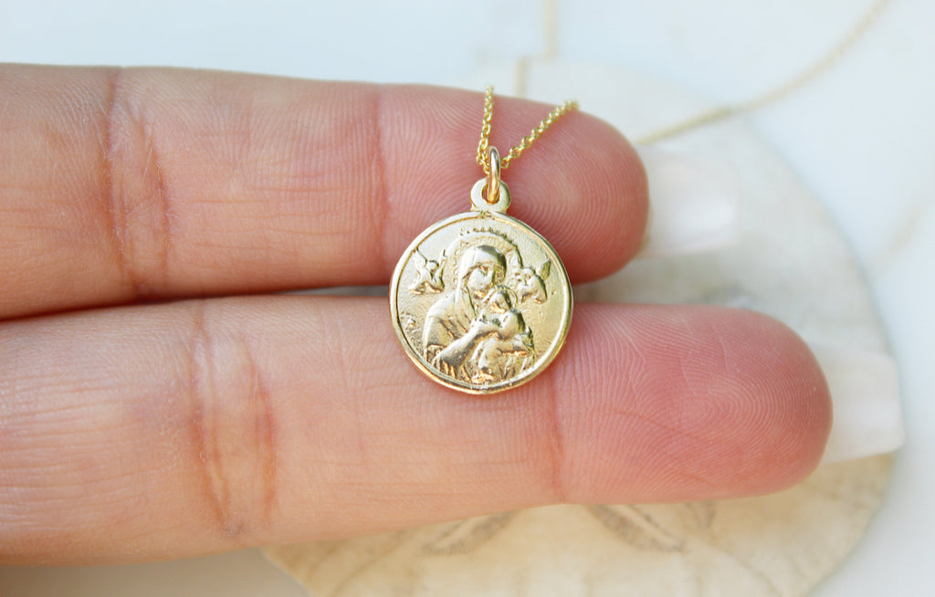 14K Yellow Gold Our Lady of Perpetual Help Necklace. Medal is handmade in USA. Medal is a circle and is 3/4"X9/16" with the loop in mind. Chain is simple and dainty. Back of Medal is blank. Markings on handmade medal are normal.