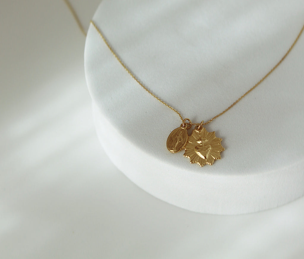 This 14k Gold Necklace has the Classic Miraculous Medal and the Sacred Heart Medal. Its handmade, the Chain is dainty.