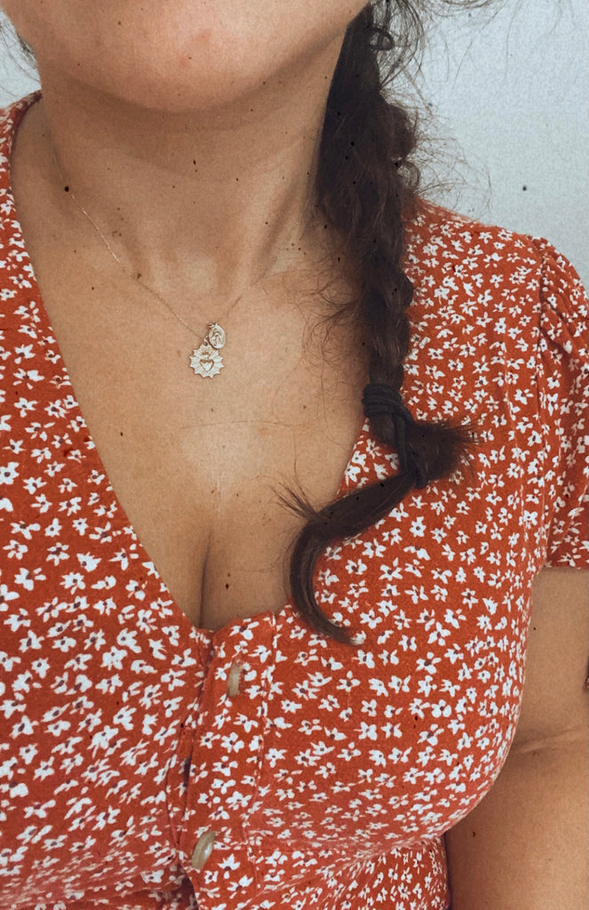 This Photo Shows the Necklace on a Model. It falls perfectly mid chest. The woman is wearing a 15-16" size.This 14k Gold Necklace has the Classic Miraculous Medal and the Sacred Heart Medal. Its handmade, the Chain is dainty.