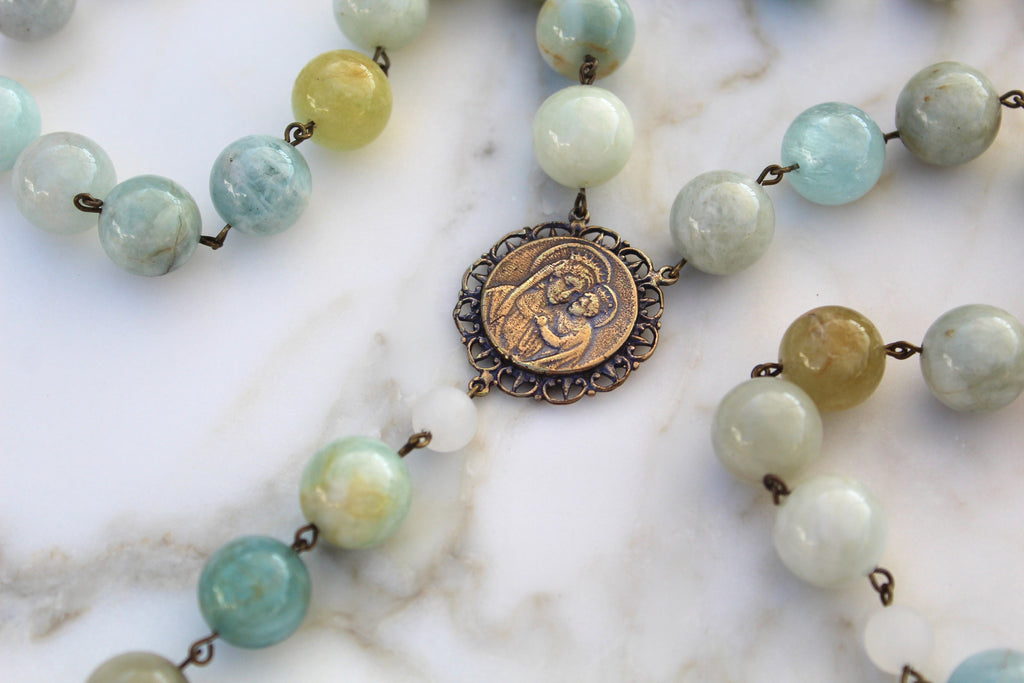 The Blue Stones on this rosary has a wide variation in color. Some of the Beads are blue, green, yellow, dark blue, light blue, and they all go together beautifully