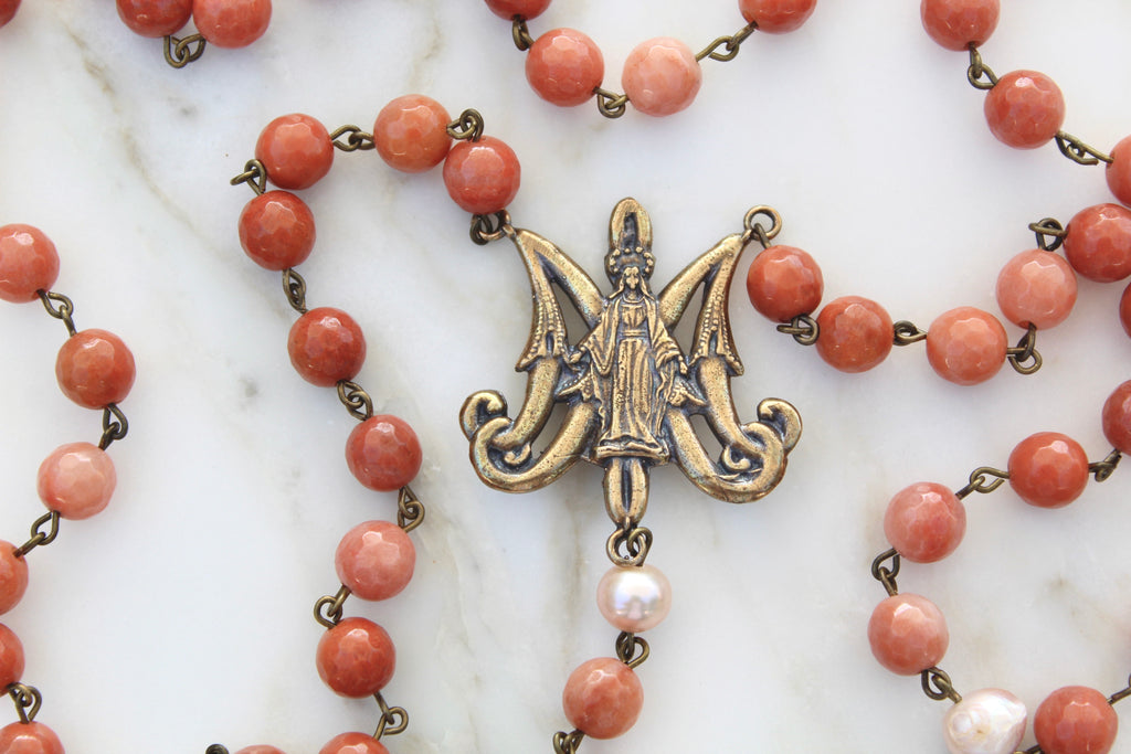 Coral colored stone rosary with Maria Auspice Symbol as the Rosary Center.
