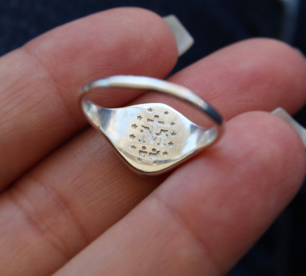 Catholic Signet Ring in Sterling Silver. It's a Miraculous Medal Signet ring. The from of the ring has mary with 6 roses, the inside has the MArian Cross with the stars and two sacred hearts. completely handmade in Southern California.