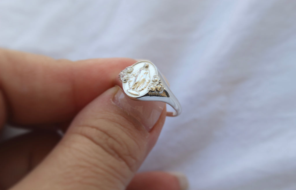 Catholic Signet Ring in Sterling Silver. It's a Miraculous Medal Signet ring. The from of the ring has mary with 6 roses, the inside has the MArian Cross with the stars and two sacred hearts. completely handmade in Southern California.