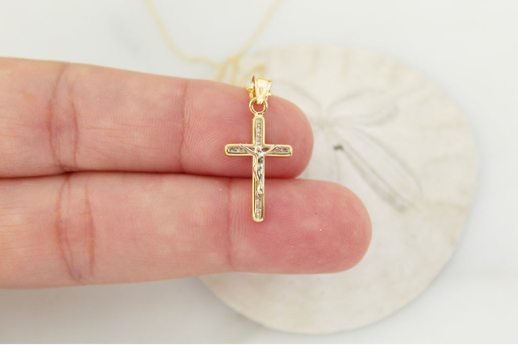 14K Gold Crucifix Pendant being held by hand model to show size of the crucifix pendant.