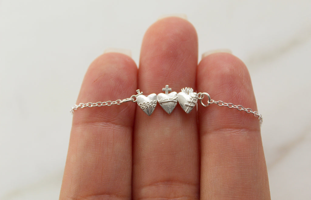This is our Holy Family Hearts® Bracelet in Sterling Silver, the Tiny version.The design displays all three hearts of the Holy Family.  The design has The Sacred Heart of Jesus, Immaculate heart of Mary, and the most Chaste heart of St. Joseph.  The Medals size on this bracelet is  3/4" X 1/2".