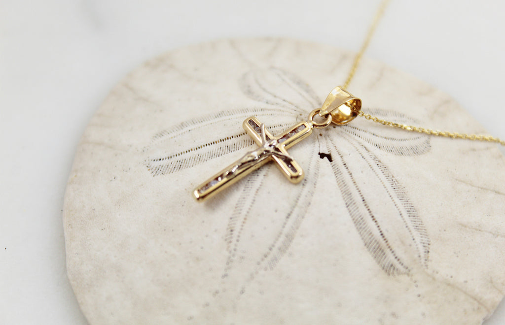 14K Gold Crucifix Pendant with Cubic Zirconias imbedded in it. This 14K Gold Crucifix sparkles  when the light hits it.