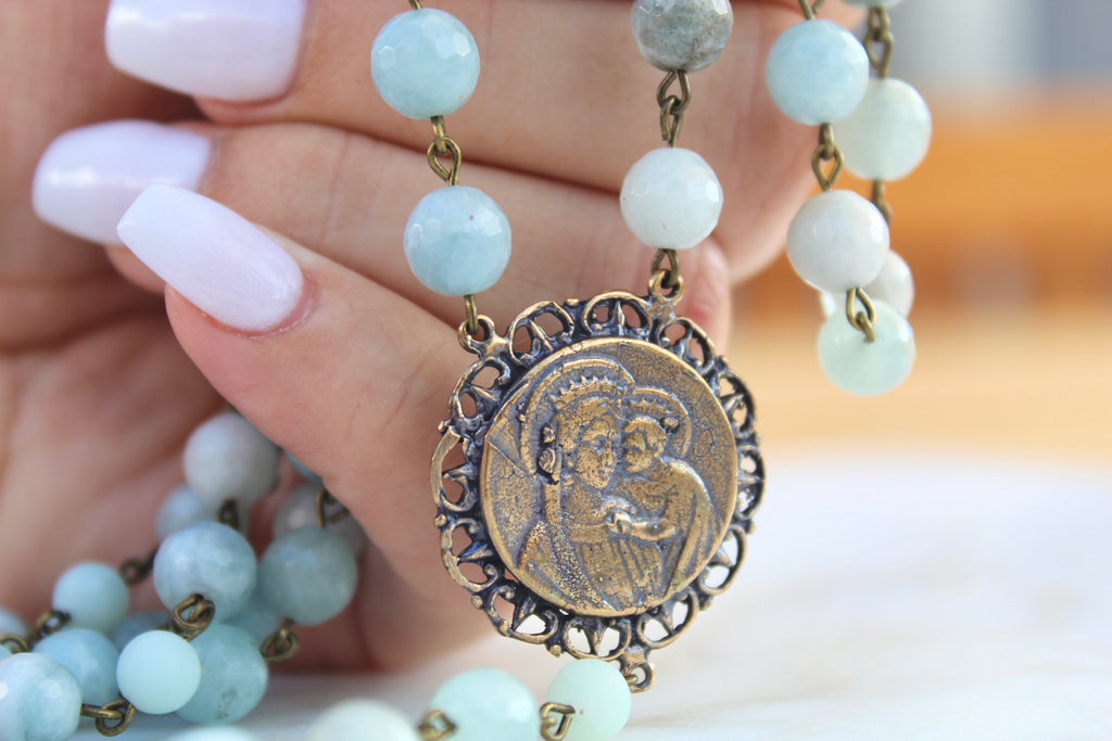 Blue Stone Rosary with Bronze center. Center has Baby Jesus and Mary Depicted.