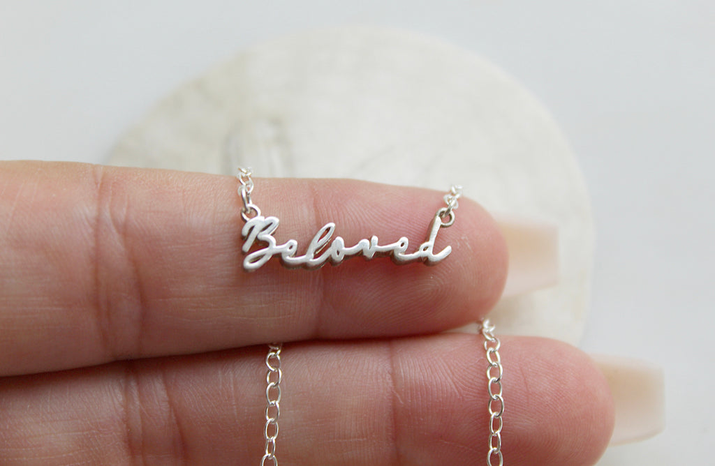This is our Beloved Necklace in Sterling Silver. It also comes in a Gold Tone. The "Beloved" Medal is in a handwriting style. Its handmade in Southern California. Chain Style: Simple Dainty Link Chain. Medal Size: 15/16" X 1/8".