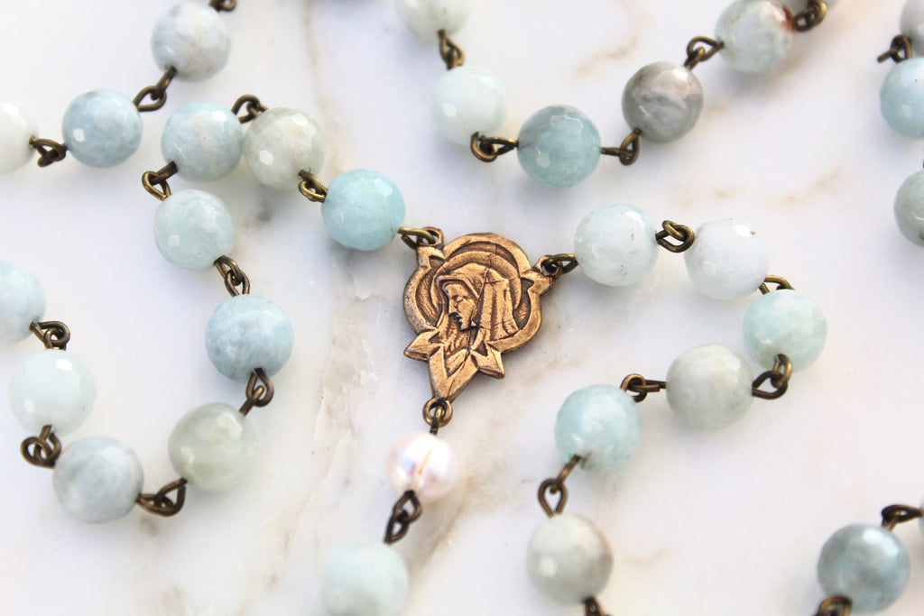 Natural Stone Rosary. Stones are Blue and vary in color. Rosary Center depicting Mary.