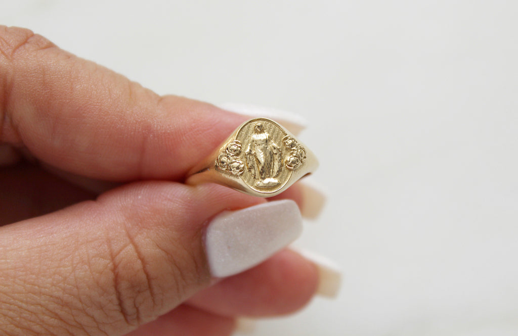 Catholic Signet Ring in 14K Yellow Gold. It's a Miraculous Medal Signet ring. The from of the ring has mary with 6 roses, the inside has the MArian Cross with the stars and two sacred hearts. completely handmade in Southern California.