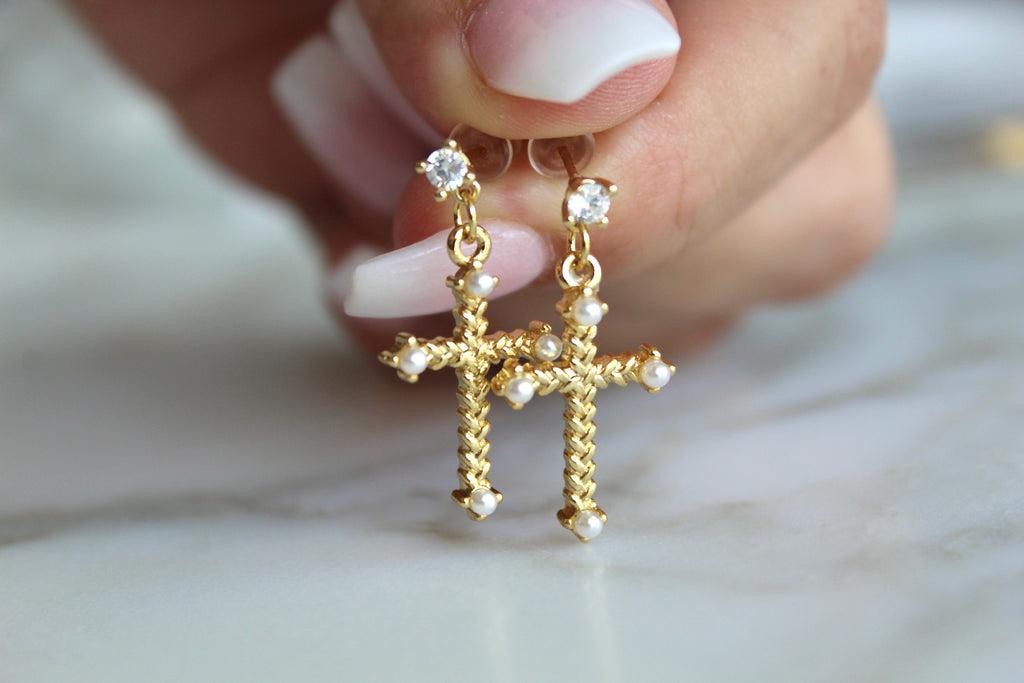 The Cross Earrings have a Dangle drop CZ post. The Cross has a Braided look and has a pearl at each end of the cross.