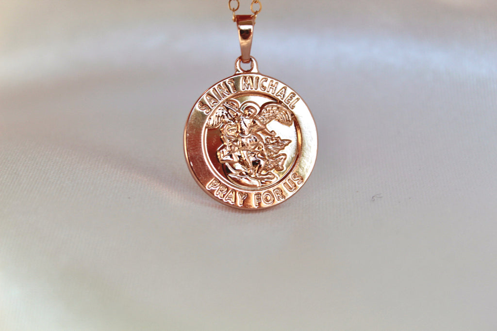 St. Michael Necklace. Pendant is round and shiny. 