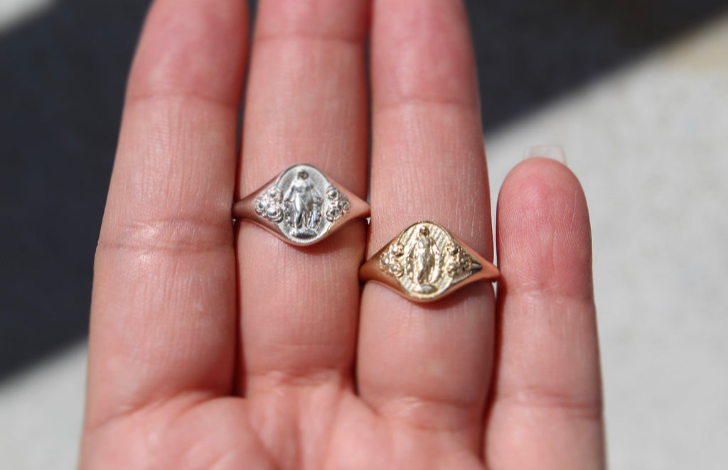 Catholic Signet Ring in 14K Yellow Gold. It's a Miraculous Medal Signet ring. The from of the ring has mary with 6 roses, the inside has the MArian Cross with the stars and two sacred hearts. completely handmade in Southern California.