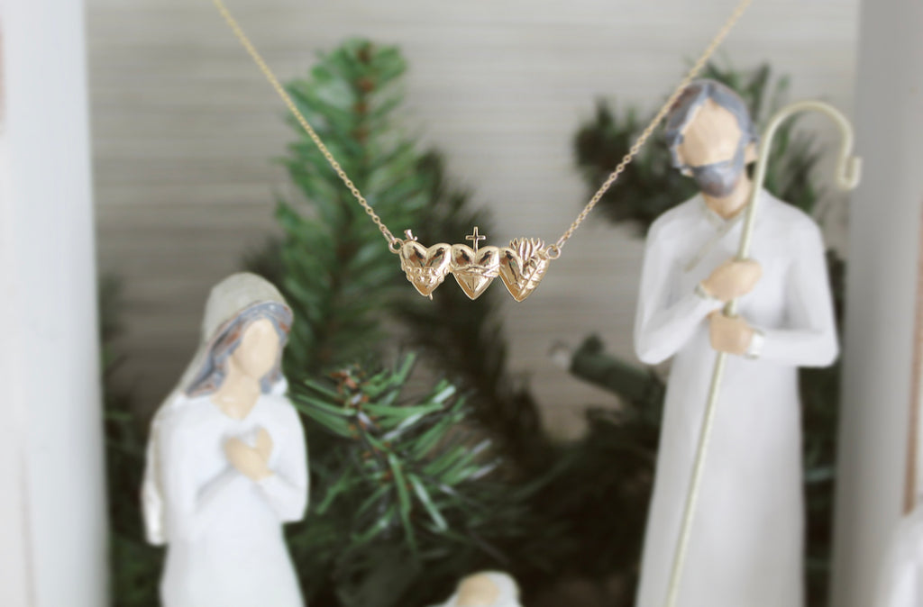 This is the Holy Family Hearts Necklace in Solid 14K Gold. This necklace has all three of the Sacred Hearts of the Holy Family. Jesus Sacred Heart, Immaculate Heart, & Chase Heart of Joseph. Ethically handmade in Southern California. Medal Size: 1" x 1/2"