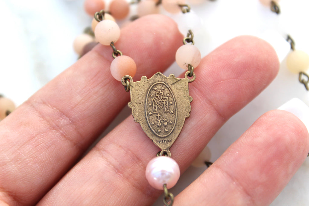 Showing the traditional Miraculous Medal image. 