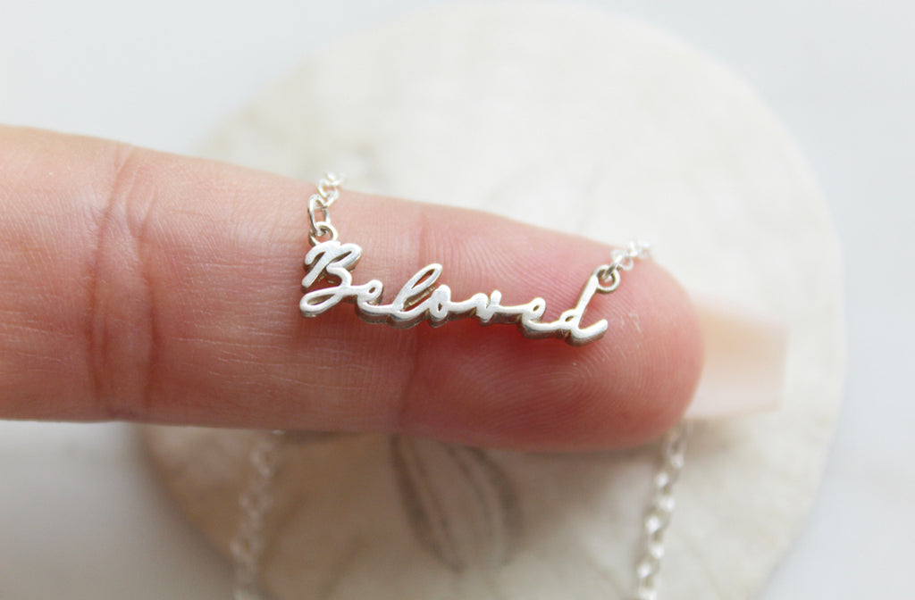 This is our Beloved Necklace in Sterling Silver. It also comes in a Gold Tone. The "Beloved" Medal is in a handwriting style. Its handmade in Southern California. Chain Style: Simple Dainty Link Chain. Medal Size: 15/16" X 1/8".